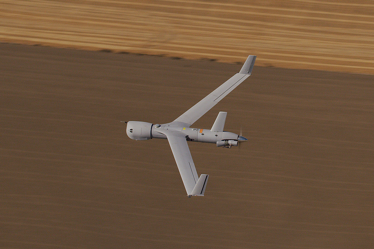 ScanEagle flying over field