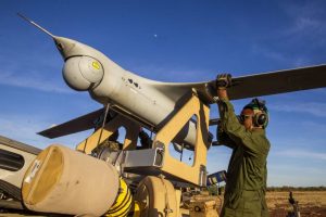 A marine with MRF-D loads an RQ-21A-Blackjack onto a launcher