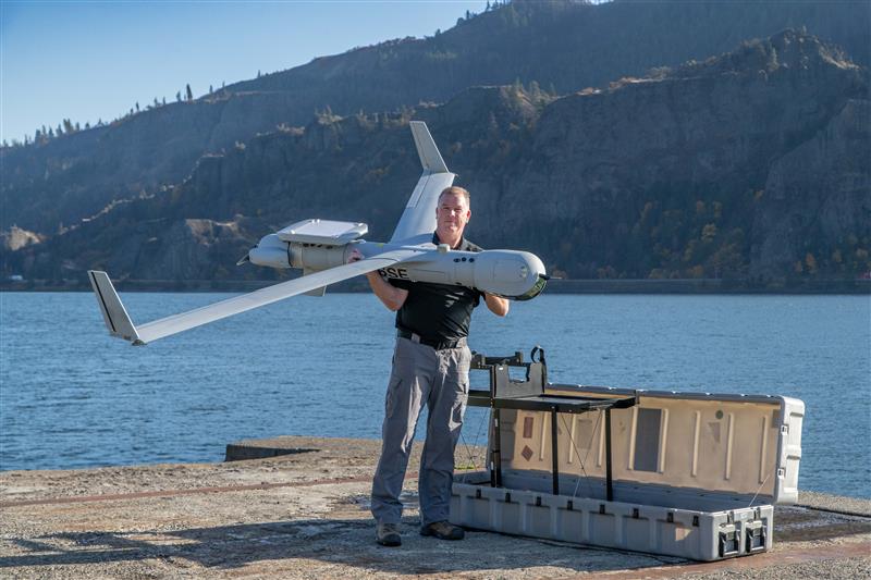 A UAS operator holds ScanEagle with PLEO SATCOM capability at Insitu Headquarters, Bingen, WA